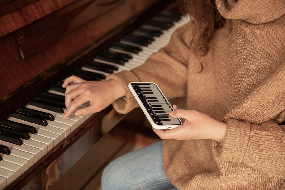 Um mulher apredendo a tocar piano digital em casa Um mulher apredendo a tocar piano digital em casa